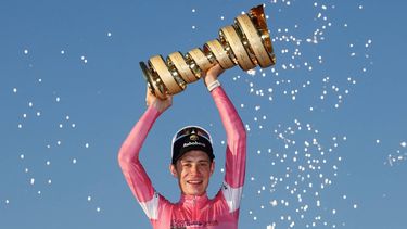 Team Visma Lease a Bike Danish rider Jonas Vingegaard wearing the overall leader's pink jersey holds the trophy as he celebrates on the podium after winning the Giro d'Italia 2026 - Tour of Italy cycling race between Rome and Rome, Italy, on May 31, 2026. 
Luca Bettini / AFP