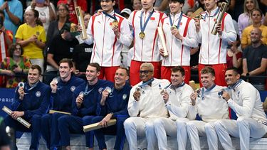 Gold medallists team China (C), silver medallists Team USA (L) and bronze medallists Team France pose on  the podium of the men's 4x100m medley relay final swimming event during the Paris 2024 Olympic Games at the Paris La Defense Arena in Nanterre, west of Paris, on August 4, 2024. 
Jonathan NACKSTRAND / AFP