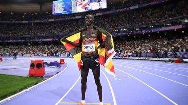 Winner Uganda's Joshua Cheptegei celebrates after crossing the finish line in the men's 10000m final of the athletics event at the Paris 2024 Olympic Games at Stade de France in Saint-Denis, north of Paris, on August 2, 2024. Uganda's Joshua Cheptegei sets a new Olympic record in the men's 10000m.
Kirill KUDRYAVTSEV / AFP