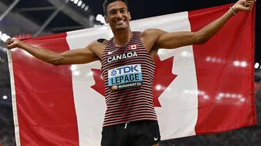 Overall decathlon winner, Canada's Pierce Lepage, celebrates with his national flag after the men's decathlon 1500m during the World Athletics Championships at the National Athletics Centre in Budapest on August 26, 2023. 
Jewel SAMAD / AFP