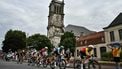 Cofidis team's French rider Benjamin Thomas (R) leads a breakaway past the Eglise catholique Saint-Martin church in Carvin, during the 1st stage of the 112th edition of the Tour de France cycling race, 184.9 km starting and finishing in Lille Metropole, northern France, on July 5, 2025. 
Marco BERTORELLO / AFP