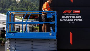 A worker stands on a hydraulic platform during preparations and contruction work at the paddock of the Red Bull Ring race track in Spielberg, Austria on June 24, 2026, ahead of the Formula One Austrian Grand Prix. 
ERWIN SCHERIAU / APA / AFP