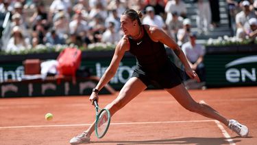 Aryna Sabalenka plays a backhand return to Australia's Daria Kasatkina during their women's singles match on day 7 of the French Open tennis tournament on Court Suzanne-Lenglen at the Roland-Garros Complex in Paris on May 30, 2026. 
Anne-Christine POUJOULAT / AFP