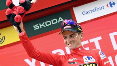 2023-09-02 17:49:52 Team Jumbo-Visma's US rider Sepp Kuss celebrates on the podium wearing the overall leader's red jersey after the stage 8 of the 2023 La Vuelta cycling tour of Spain, a 165 km race from Denia to Xorret de Cati, in Castalla, on September 2, 2023. 
JOSE JORDAN / AFP