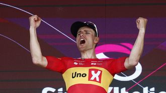 Uno X Mobility Norwegian rider Fredrik Dversnes celebrates on the podium after winning the 15th stage of the Giro d'Italia 2026 - Tour of Italy cycling race between Voghera and Milan, Italy, on May 24, 2026. 
Luca Bettini / AFP
