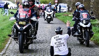 A protestor sits on the road while riders compete in the 'Ronde van Brugge' men's elite one-day cycling race, 202,9 km from and to Bruges on March 25, 2026. 
MAARTEN STRAETEMANS / Belga / AFP