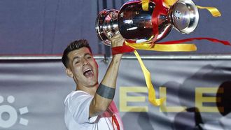 Spain's forward #07 Alvaro Morata celebrates with the trophee as Spanish national football team players celebrate on the stage with fans at Cibeles Square in Madrid on July 15, 2024, after Spain won the UEFA Euro 2024 final football match between Spain and England.  
OSCAR DEL POZO / AFP