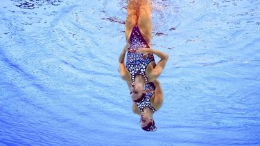 An underwater view shows Netherlands' Bregje De Brouwer and Netherlands' Noortje De Brouwer competing in the duet technical routine of the artistic swimming event during the Paris 2024 Olympic Games at the Aquatics Centre in Saint-Denis, north of Paris, on August 9, 2024. 
Oli SCARFF / AFP