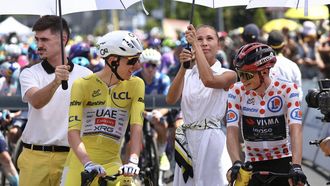 UAE Team Emirates - XRG's Slovenian rider Tadej Pogacar wearing the overall leader's yellow jersey and Team Visma | Lease a Bike's Danish rider Jonas Vingegaard wearing the climber's dotted 