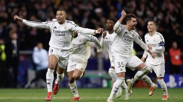 Real Madrid's French forward #09 Kylian Mbappe (L) and Real Madrid's Spanish defender #35 Raul Asencio celebrate with teammates after winning in a penalty shootout the UEFA Champions League Round of 16 second leg football match between Club Atletico de Madrid and Real Madrid CF at the Metropolitano stadium in Madrid on March 12, 2025. 
OSCAR DEL POZO / AFP