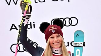 Third-placed US Lindsey Vonn celebrates on the podium of the women's Super G event during the FIS Alpine Ski World Cup 2025-2026, in Val d'Isere, southwestern France, on December 21, 2025. 
Jeff PACHOUD / AFP