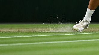 Shards of grass spring up next to the shoe of Denmark's Holger Rune as he returns the ball to Serbia's Novak Djokovic during their men's singles tennis match on the eighth day of the 2024 Wimbledon Championships at The All England Lawn Tennis and Croquet Club in Wimbledon, southwest London, on July 8, 2024. 
Ben Stansall / AFP