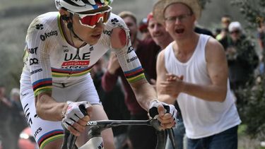 Team UAE's slovenain rider Tadej Pogacar rides as he sustains an injury on his arm after a crash during the 19th one-day classic Strade Bianche (White Roads) men's cycling race between Siena and Siena in Tuscany on March 8, 2025. 
Marco BERTORELLO / AFP