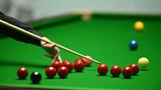 Wales' Jak Jones makes a bridge over the reds as he plays a shot on day two of his World Championship Snooker final  against England's Kyren Wilson during the afternoon session at The Crucible in Sheffield, northern England on May 6, 2024.  
Oli SCARFF / AFP