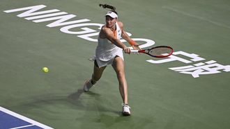 Kazakhstan's Elena Rybakina hits a return to Australia's Ajla Tomljanovic during their women’s singles quarter-final match at the WTA Ningbo Open tennis tournamen in Ningbo, China’s eastern Zhejiang province on October 17, 2025. 
STR / AFP