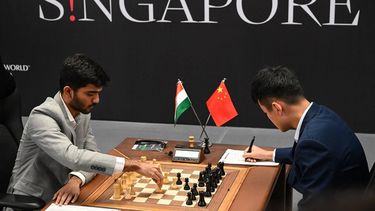 China’s chess grandmaster Ding Liren (R) and India’s chess grandmaster Gukesh Dommaraju (L) compete during the start of the FIDE World Chess Championship in Singapore on November 25, 2024. 
Roslan RAHMAN / AFP