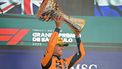 McLaren's British driver Lando Norris lifts the trophy on the podium after winning the Sao Paulo Formula One Grand Prix at the Jose Carlos Pace racetrack, aka Interlagos, in Sao Paulo, Brazil on November 9, 2025. 
Nelson ALMEIDA / AFP