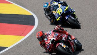 Ducati Lenovo Team's Spanish driver Marc Marquez (front) and BK8 Gresini Racing Team's Spanish driver Alex Marquez race during the German Motorcycle MotoGP Grand Prix at the Sachsenring race track in Hohenstein-Ernstthal near Chemnitz, eastern Germany, on July 12, 2026. 
Ronny HARTMANN / AFP
