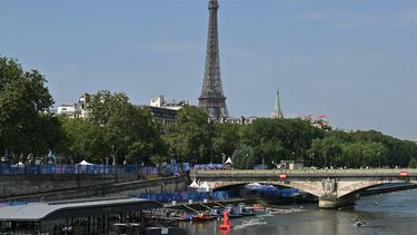 The Eiffel Tower is seen as athletes compete in the swimming stage in the Seine during the men's individual triathlon at the Paris 2024 Olympic Games in central Paris on July 31, 2024. 
Andrej ISAKOVIC / AFP