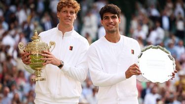 Italy's Jannik Sinner (L) holding the winner's trophy and second-placed Spain's Carlos Alcaraz pose for pictures during the price ceremony at the end of their men's singles final tennis match on the fourteenth day of the 2025 Wimbledon Championships at The All England Lawn Tennis and Croquet Club in Wimbledon, southwest London, on July 13, 2025. 
HENRY NICHOLLS / AFP
