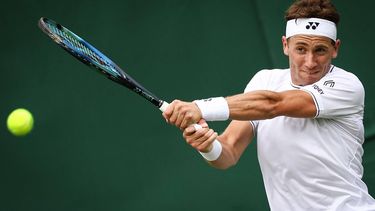 Norway's Casper Ruud returns the ball to Australia's Alex Bolt during their men's singles tennis match on the first day of the 2024 Wimbledon Championships at The All England Lawn Tennis and Croquet Club in Wimbledon, southwest London, on July 1, 2024. 
HENRY NICHOLLS / AFP