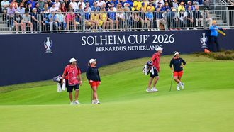 US teams golfer Megan Khang (R) and US teams golfer Lauren Coughlin (2L) stand with their caddies during play in their fourball match against Team Europe players on the second day of the 2026 Solheim Cup biennial team golf competition on The Bernardus Golf Course at Cromvoirt, some 80kms south-east of Rotterdam on September 12, 2026.  
NICOLAS TUCAT / AFP