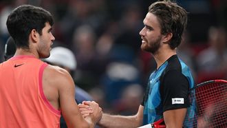 Czech Republic's Tomas Machac (R) shakes hands after winning against Spain’s Carlos Alcaraz during their men's singles match at the Shanghai Masters tennis tournament in Shanghai on October 10, 2024. 
HECTOR RETAMAL / AFP
