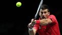 Serbia's Novak Djokovic returns the ball against Italy's Jannik Sinner during the second men's singles semifinal tennis match between Italy and Serbia of the Davis Cup tennis tournament at the Martin Carpena sportshall, in Malaga on November 25, 2023. 
LLUIS GENE / AFP