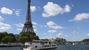 2023-07-17 11:21:31 A Peniche boat sails past the Eiffel Tower on the River Seine on July 17, 2023, during a parade to test 