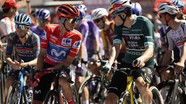 Overall leader Team Movistar's Spanish rider Enric Mas (L) speaks with points leader Team Visma-Lease a bike's Belgian rider Wout van Aert before the start of the 20th stage of the Vuelta a Espana 2026 cycling tour, a 186,8 km race between La Calahorra and Collado del Alguacil, on September 12, 2026.  
JORGE GUERRERO / AFP