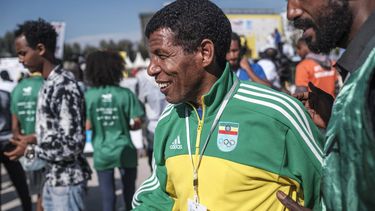 Haile Gebreselassie, founder of the event and retired long distance runner, gets his photo taken with his fans during the 21st edition of the Great Ethiopian Run, in the city of Addis Ababa, Ethiopia, on January 23, 2022. 
EDUARDO SOTERAS / AFP