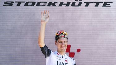 epa12191191 UAE Team Emirates rider Joao Almeida from Portugal celebrates on the podium after winning the eigth and final stage of the Tour de Suisse cycling race, a 10.1 km individual time trial from Beckenried to Stockhuette, Switzerland, 22 June 2025.  EPA/GIAN EHRENZELLER