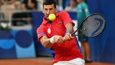 Serbia's Novak Djokovic returns to Italy's Lorenzo Musetti during their men's singles semi-final tennis match on Court Philippe-Chatrier at the Roland-Garros Stadium during the Paris 2024 Olympic Games, in Paris on August 2, 2024.  
Miguel MEDINA / AFP