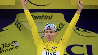 epa11476239 Slovenian rider Tadej Pogacar of UAE Team Emirates celebrates in the overall leader's yellow jersey on the podium after winning the 14th stage of the 2024 Tour de France cycling race over 151km from Pau to Saint-Lary-Soulan Pla d'Adet, France, 13 July 2024.  EPA/GUILLAUME HORCAJUELO