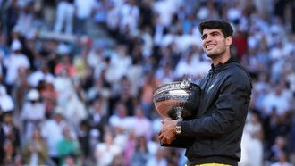 Spain's Carlos Alcaraz celebrates with the trophy after winning against Germany's Alexander Zverev at the end of their men's singles final match on Court Philippe-Chatrier on day fifteen of the French Open tennis tournament at the Roland Garros Complex in Paris on June 9, 2024. 
ALAIN JOCARD / AFP