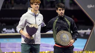 Italy's Jannik Sinner poses with the winner's trophy next to Spain's Carlos Alcaraz during the awards ceremony after their final tennis match in the 