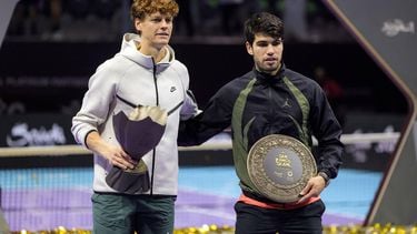 Italy's Jannik Sinner poses with the winner's trophy next to Spain's Carlos Alcaraz during the awards ceremony after their final tennis match in the 