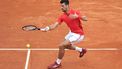 Serbia's Novak Djokovic plays a forehand return to Russia's Roman Safiullin during their Monte Carlo ATP Masters Series Tournament round of 32 tennis match on the Rainier III court at the Monte Carlo Country Club on April 9, 2024. 
Valery HACHE / AFP