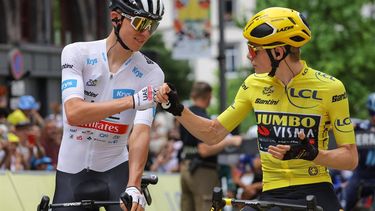 2023-07-12 13:17:33 UAE Team Emirates' Slovenian rider Tadej Pogacar wearing the best young rider's white jersey (L) bumps fists with Jumbo-Visma's Danish rider Jonas Vingegaard wearing the overall leader's yellow jersey (R) as they await the start of the 11th stage of the 110th edition of the Tour de France cycling race, 180 km between Clermont-Ferrand and Moulins, in central France, on July 12, 2023. 
Thomas SAMSON / AFP
