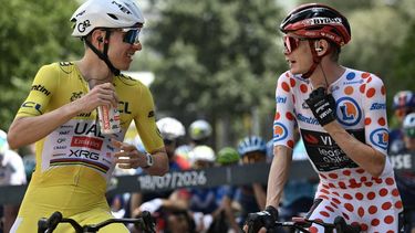UAE Team Emirates - XRG's Slovenian rider Tadej Pogacar wearing the overall leader's yellow jersey (L) speaks with Team Visma | Lease a Bike's Danish rider Jonas Vingegaard wearing the climber's dotted 