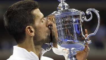 2023-09-11 03:05:38 Serbia's Novak Djokovic kisses the trophy after defeating Russia's Daniil Medvedev during the US Open tennis tournament men's singles final match at the USTA Billie Jean King National Tennis Center in New York City, on September 10, 2023. 
kena betancur / AFP
