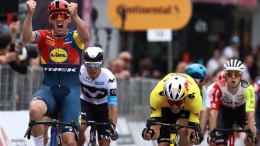 Lidl-Trek's Danish rider Mads Pedersen, next to Team Visma-Lease a Bike's Belgian rider Wout Van Aert (R), celebrates as he crosses the finish to win the first stage of the 108th Giro d'Italia cycling race, 160km from Durres to Tirana in Albania, on May 9, 2025.  
Luca Bettini / AFP