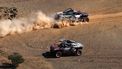 Team Audi Sport's Spanish driver Carlos Sainz and his Spanish co-driver Lucas Cruz steer their car (top) as Team Audi Sport's French driver Stephane Peterhansel and his French co-driver Edouard Boulanger wait for them during the stage 11 of the 2024 Dakar Rally between Al-Ula and Yanbu, Saudi Arabia, on January 18, 2024. 
PATRICK HERTZOG / AFP