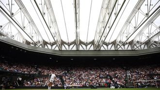 Russia's Daniil Medvedev serves under the closed roof of Centre Court as he plays against Italy's Jannik Sinner during their men's singles quarter-final tennis match on the ninth day of the 2024 Wimbledon Championships at The All England Lawn Tennis and Croquet Club in Wimbledon, southwest London, on July 9, 2024. 
HENRY NICHOLLS / AFP