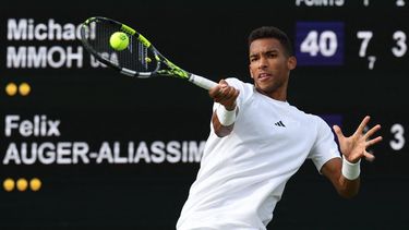 2023-07-03 17:51:50 Canada's Felix Auger-Aliassime returns the ball to US player Michael Mmoh during their men's singles tennis match on the first day of the 2023 Wimbledon Championships at The All England Tennis Club in Wimbledon, southwest London, on July 3, 2023.  
Adrian DENNIS / AFP