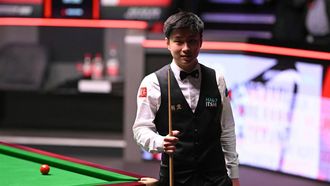 China's Zhao Xintong reacts having lost the first four frames of the final session, on day two of his World Championship Snooker final against Wales' Mark Williams at The Crucible in Sheffield, northern England on May 5, 2025.  
Oli SCARFF / AFP