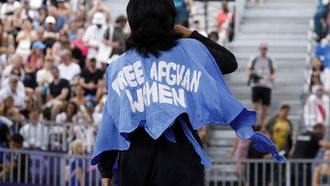 Refugee Olympic team's Manizha Talash, known as Manizha wears a jacket reading 