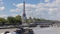 A Paris police (DOPC) boat (bottom L) makes its way past a cruise boat along the Seine River in Paris on July 4, 2024. 
JOEL SAGET / AFP