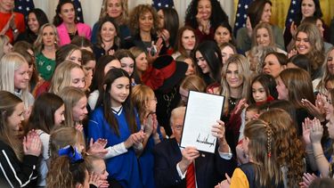 US President Donald Trump holds the signed No Men in Women's Sports Executive Order into law in the East Room of the White House in Washington, DC, on February 5, 2025. President Trump on Wednesday is signing an executive order to ban transgender girls and women from competing on sports teams that match their gender identity, marking his latest move targeting transgender rights. 
ANDREW CABALLERO-REYNOLDS / AFP
