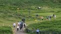 Spectators make their way off the course as practice is suspended due to the weather ahead of the 153rd Open Championship at Royal Portrush golf club in Northern Ireland on July 14, 2025. 
ANDY BUCHANAN / AFP